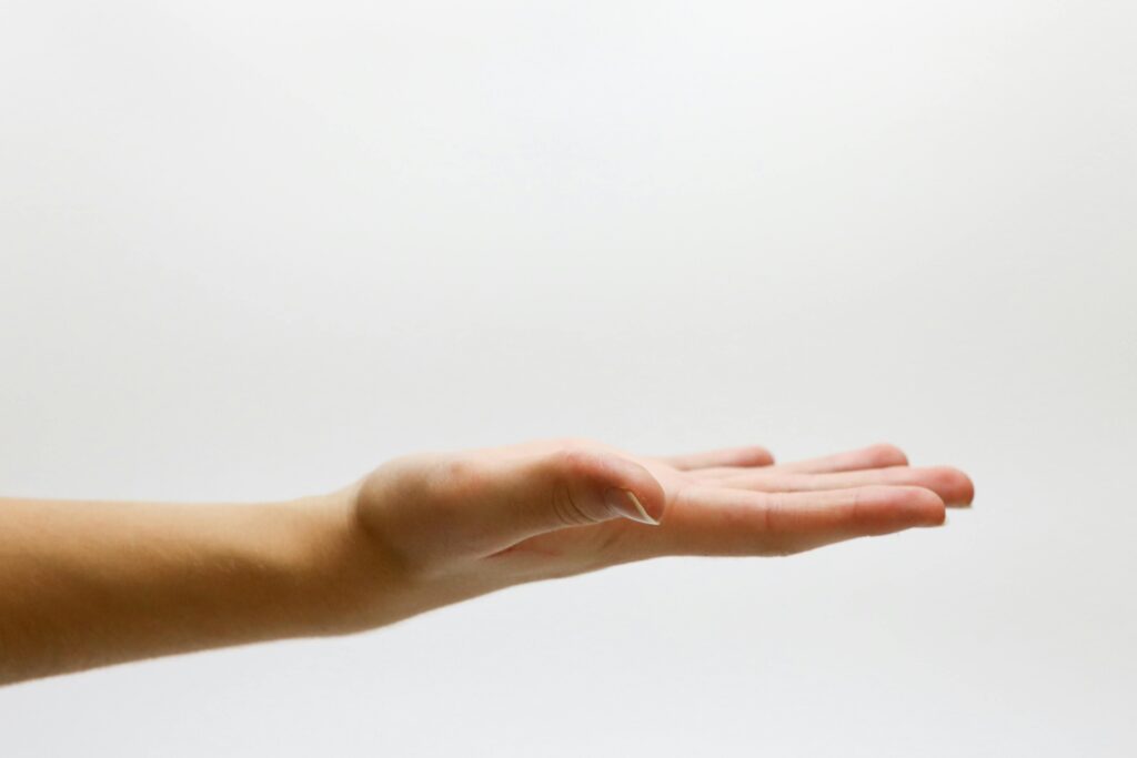 Detailed close-up of an open human hand on a white background, emphasizing gestures and expressions.